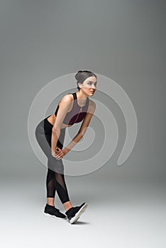 sportive woman in black leggings warming