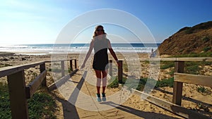 Sportive woman doing jumping rope on the beach