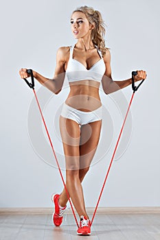 Sportive woman doing skipping rope in the gym