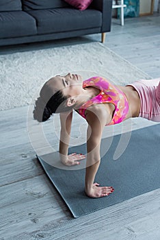 sportive woman exercising in yoga pose