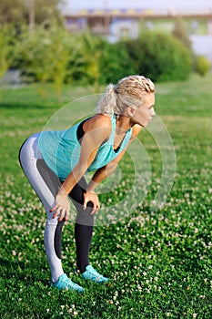 Sportive woman having rest after jogging