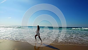 Sportive woman jogging on the beach