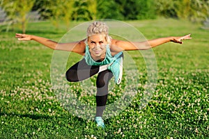 sportive woman practicing balancing yoga