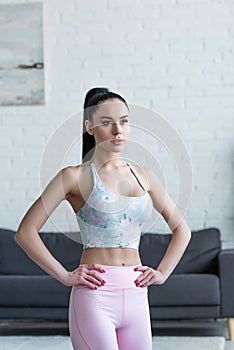 sportive woman in sports bra standing