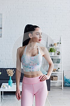 sportive woman in sports bra standing