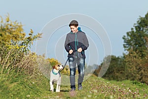 Sportive woman walks her dog in autumn