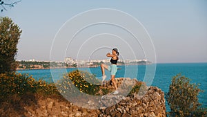 Sportive woman working out on the hill by the sea - running on the spot