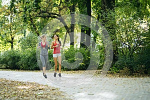 Sportive women jogging in park