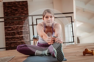 Sportive young lady with accurate manicure and dark nails