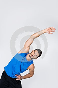 sportive young man doing side bend