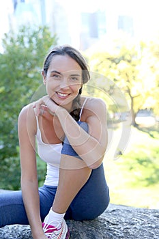 Sportive young woman in central park excercising