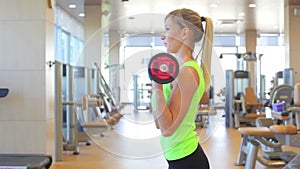 Sportive young woman doing exercise with barbell