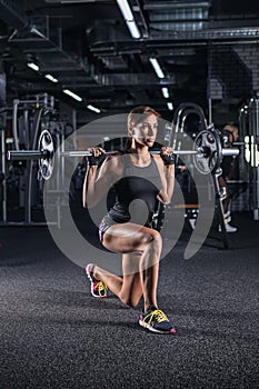 Sportive young woman in a gym training.