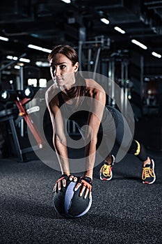 Sportive young woman in a gym training.