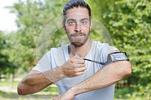 Sportman with music bandage in arm