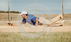 Sports, action and a man catching baseball, sliding in dust on floor with ball in baseball glove. Slide, dive and catch