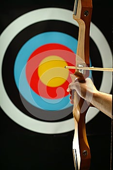 Sports archer preparing to fire photo