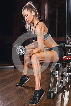 Sports background. Muscular fit woman exercising.