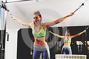 Sports background. Muscular fit woman exercising.