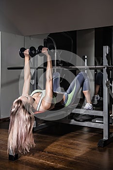 Sports background. Muscular fit woman exercising.