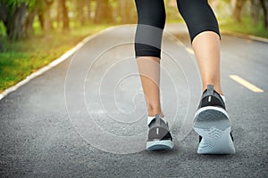 Sports background, Runner feet running on road closeup on shoe, Sport woman running on road at sunrise, Fitness and workout