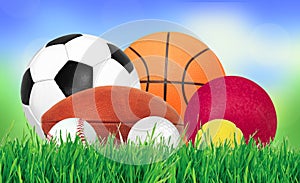 Sports balls over green grass over nature background