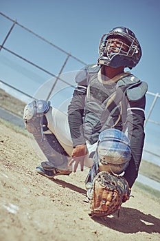 Sports, baseball and catcher ready in a game, match or training on outdoor baseball field. Fitness, exercise and