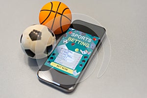 Sports betting website in a mobile phone screen, ball, money