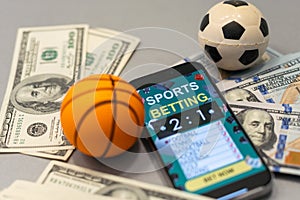 Sports betting website in a mobile phone screen, ball, money