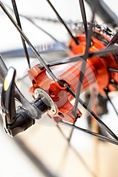 Sports bicycle red rear axle with racing cassette gears on light weight rims