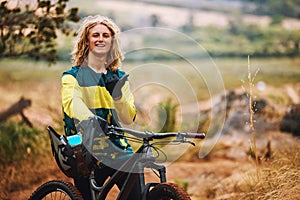 Sports, bike and cyclist man hand sign in nature on a park trail with a smile. Portrait of an adventure athlete on a