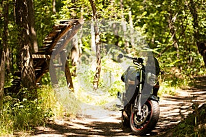 Sports black motorcycle near the power plant.