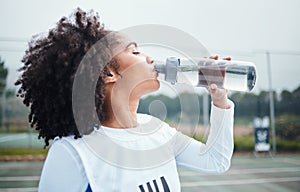 Sports, black woman and drinking water at court during training, workout and sport exercise outdoors. Fitness, thirsty