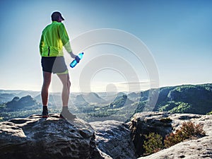 Sports bottle drink sport man drinking water on trail run photo