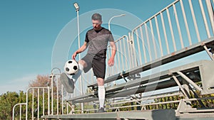 Sports boy dribbles with soccer ball in the stands