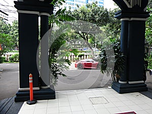 Sports car in the city parked at the entrance to the hotel.