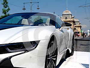 Sports car detail and cityscape in Budapest on bright summer day