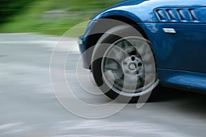 Sports car front wheel spinning and turning