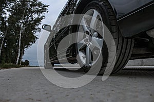 Sports car side view, alloy wheels