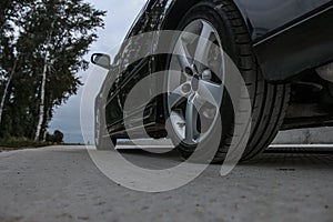Sports car side view, alloy wheels photo