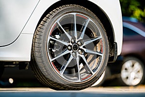 Sports car wheels, low profile tires on aluminum rims, closeup