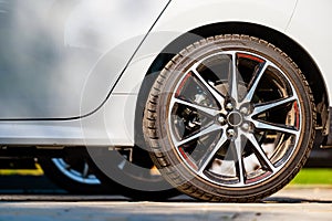 Sports car wheels, low profile tires on aluminum rims, closeup