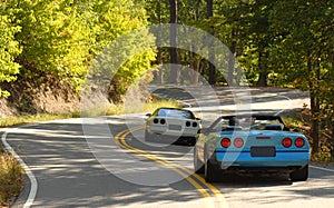 Sports cars on a winding road photo