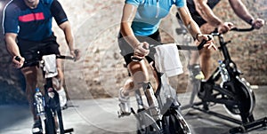 Sports clothing people riding exercise bikes