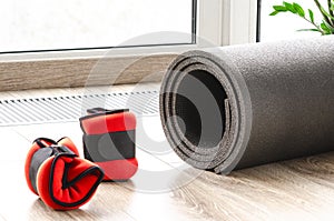 Sports concept. Healthy lifestyle. Fitness mat and weights for arms and legs