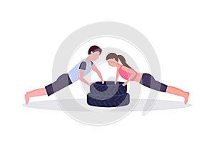 Sports couple doing push-up exercise on tires man woman working out in gym crossfit training healthy lifestyle concept