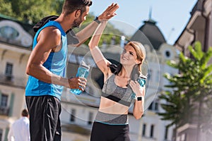 Sports couple giving highfive