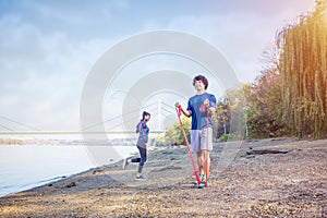 Sports couple training outdoors-man working out with resistance