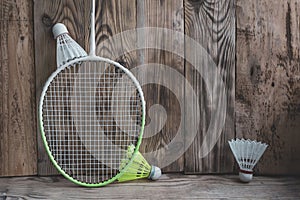 Sports equipment for bambinton on vinage wood background.