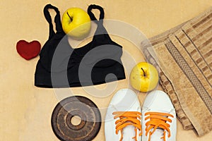 Sports equipment flat lay, and sneakers, old metal dumbbells and apples and heart pillow. Concept healthy lifestyle, sport and die